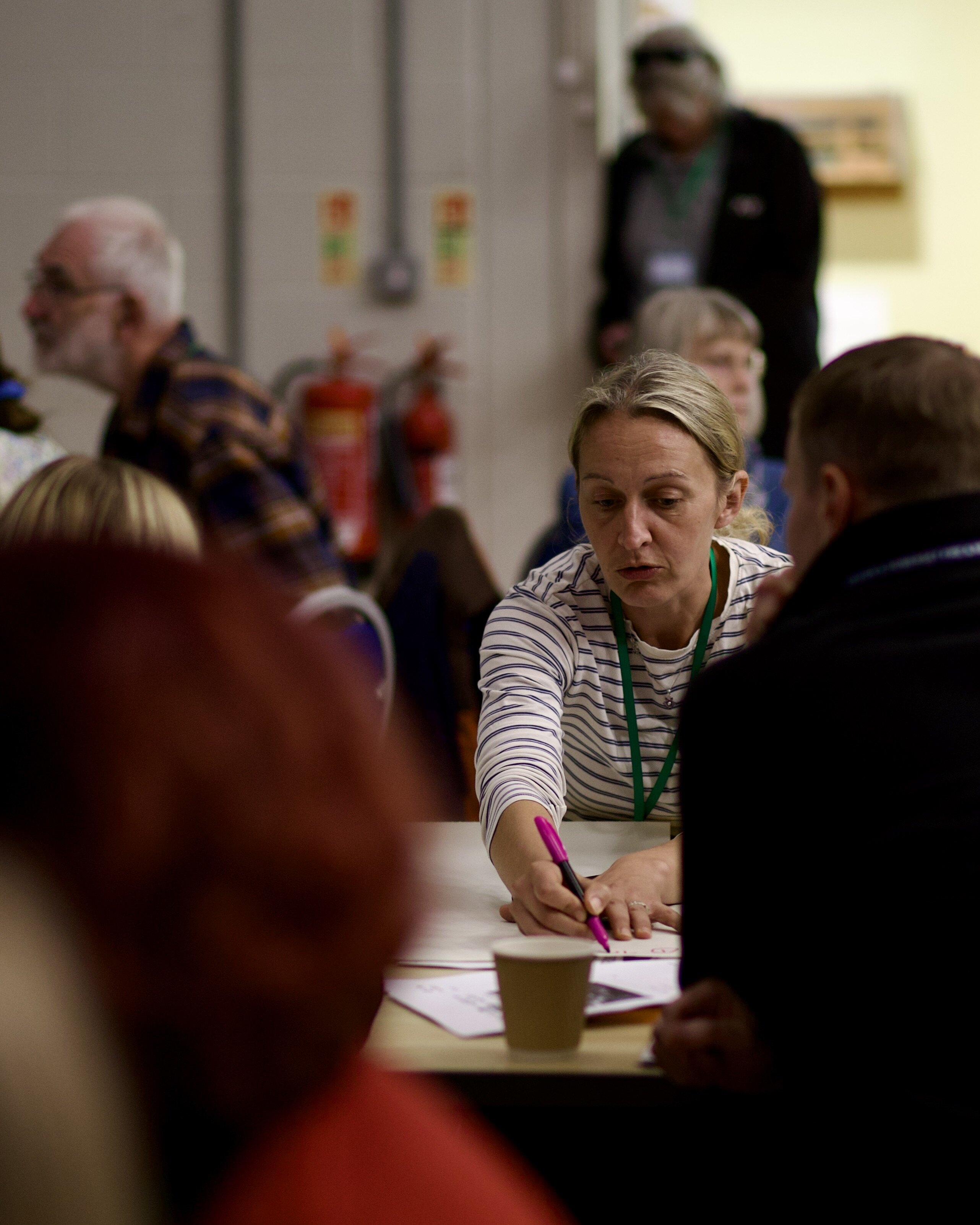 Delegates discussing and writing notes