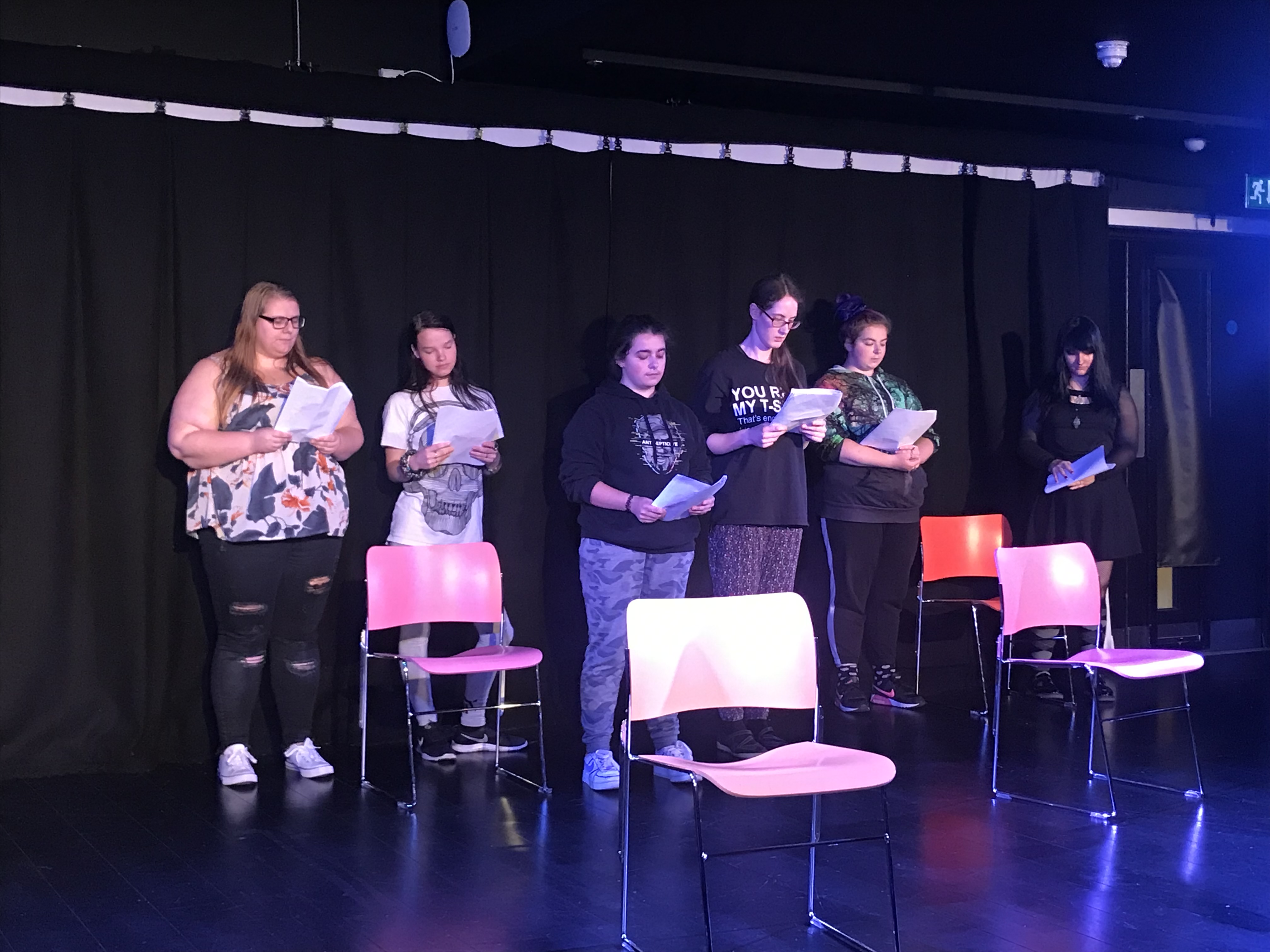 Group of young people standing on a stage