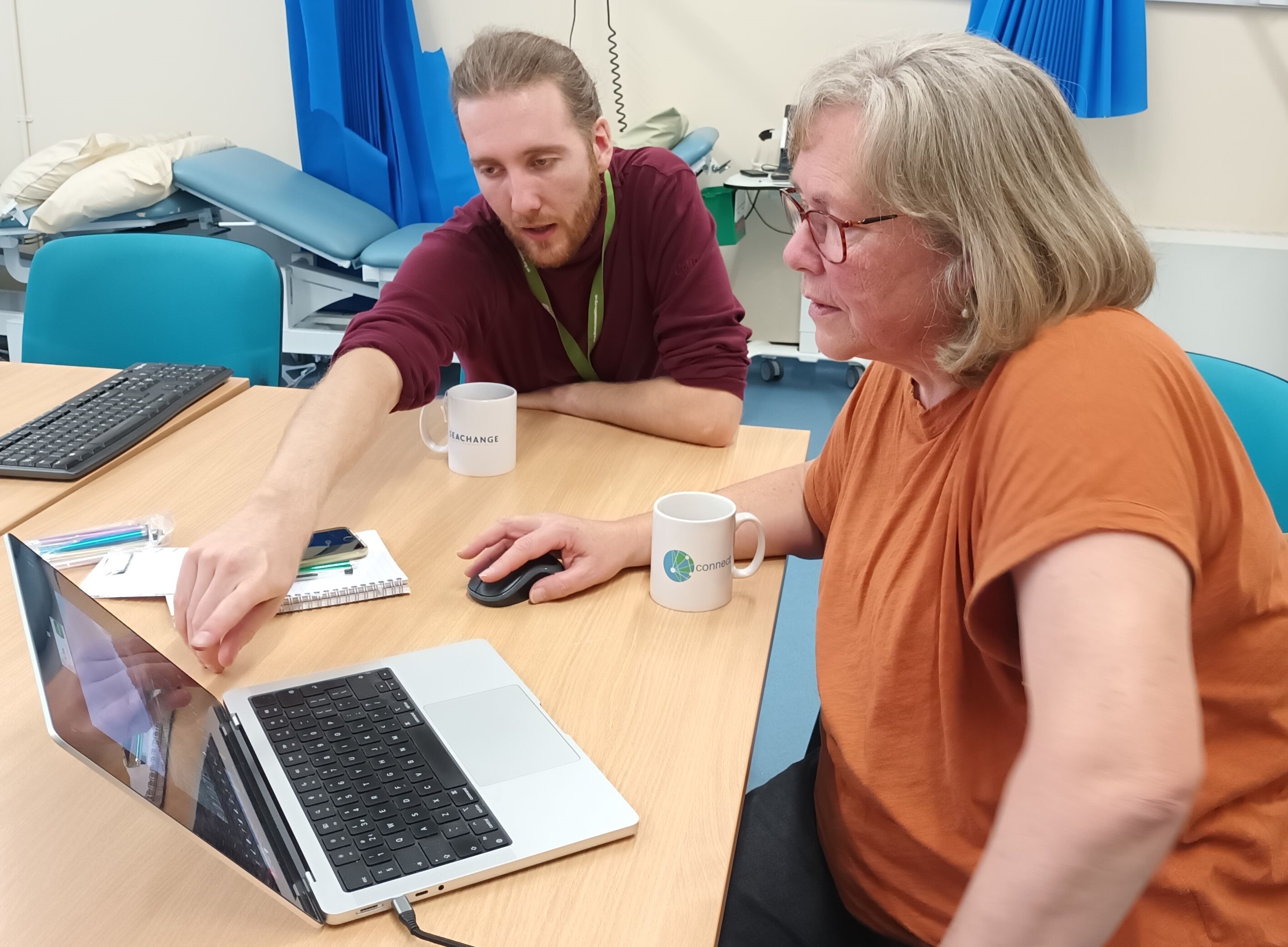 Two people looking at a laptop