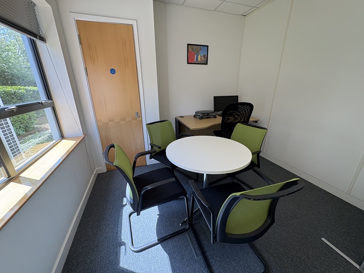 small meeting room woth green chairs