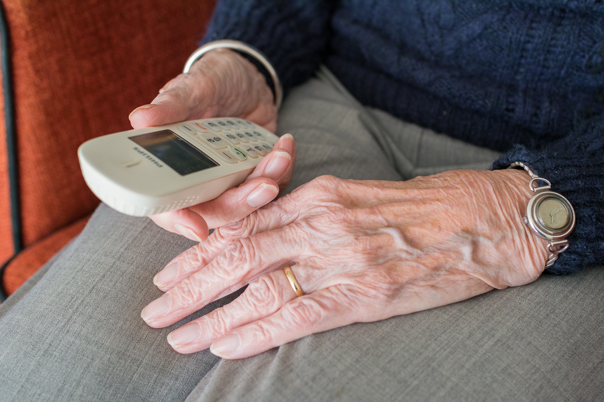 Older person hand and phone
