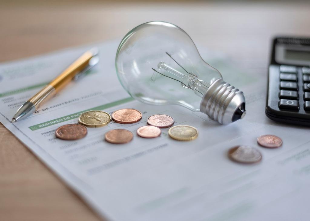 Light bulb, coins and paper