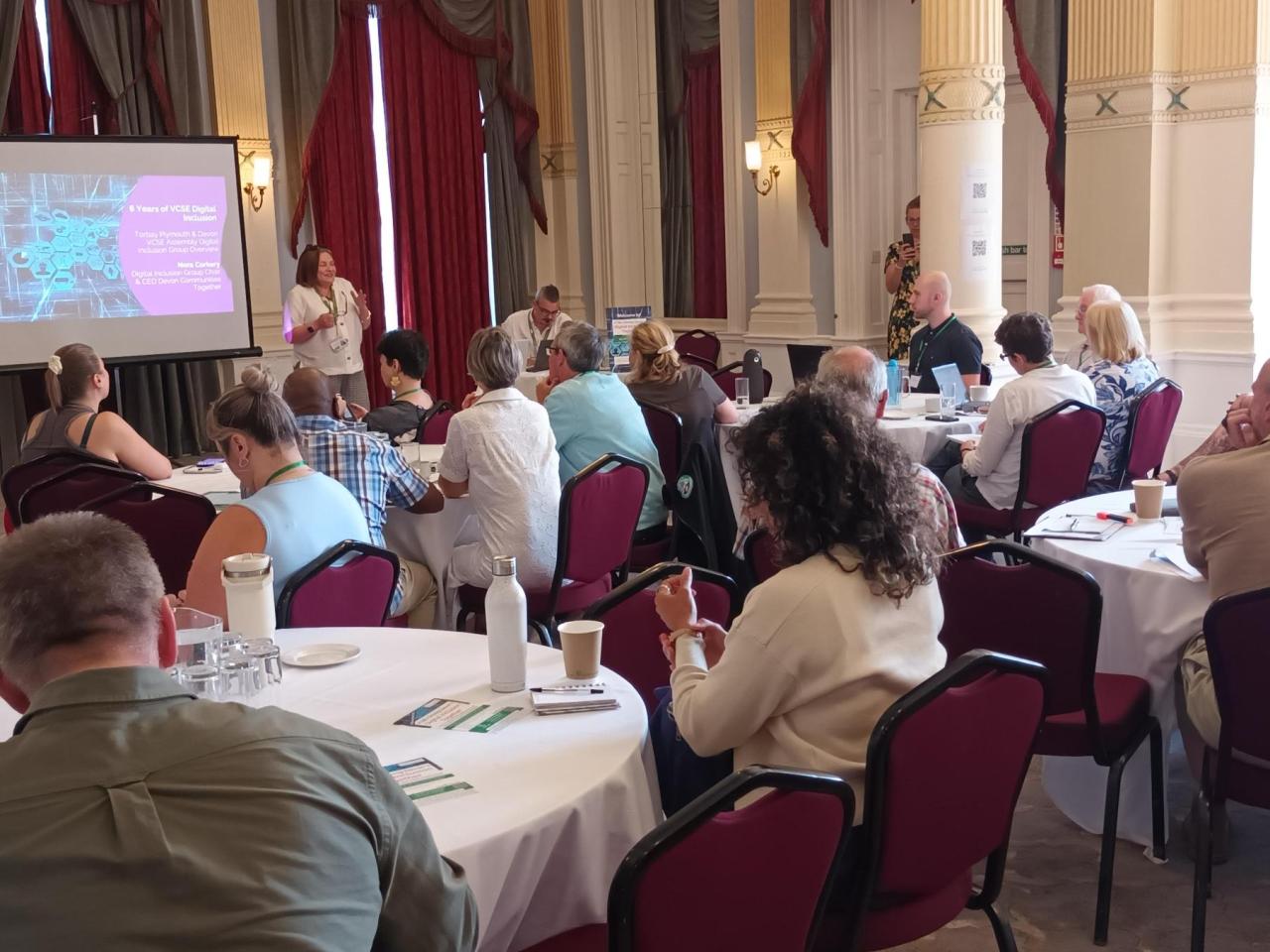 people sat around a table at a conference