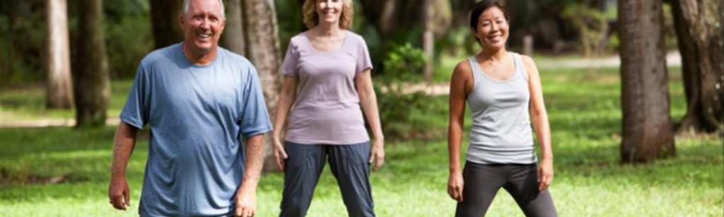 older people exercising in a park