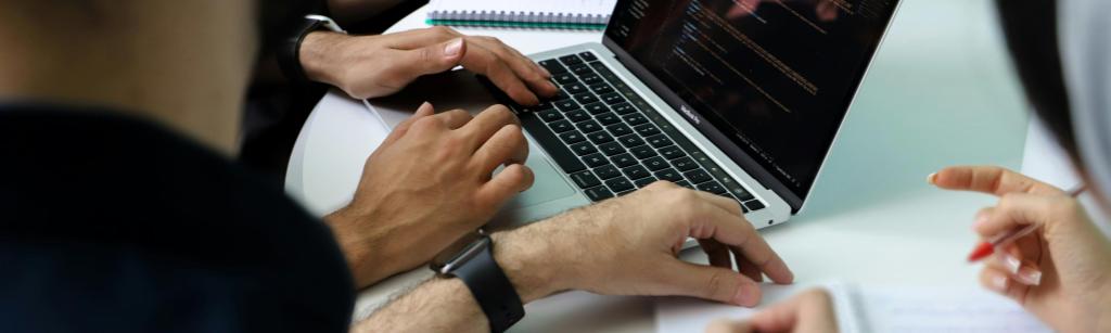 Hands around laptop. Credit Fatemah Rezvani via unsplash.
