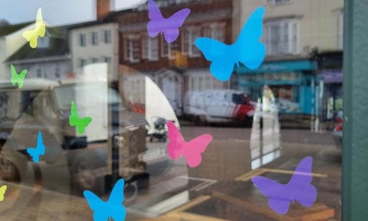 butterfly stickers ona window overlooking some shops