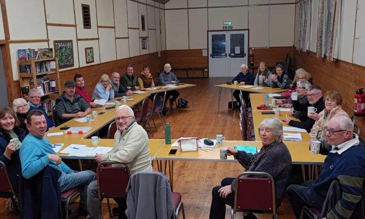 Torridge VH cluster meeting, group of people smiling in a village hall