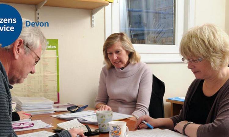 Older people at a desk being given advice