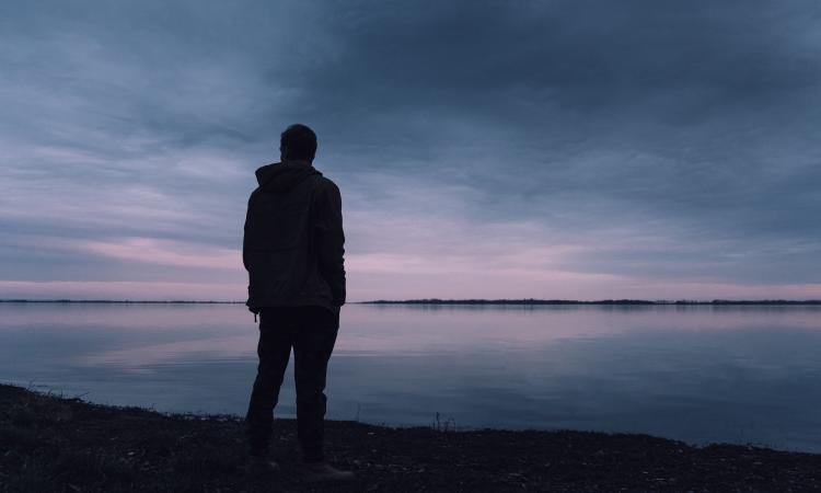 A person looking out over body of water