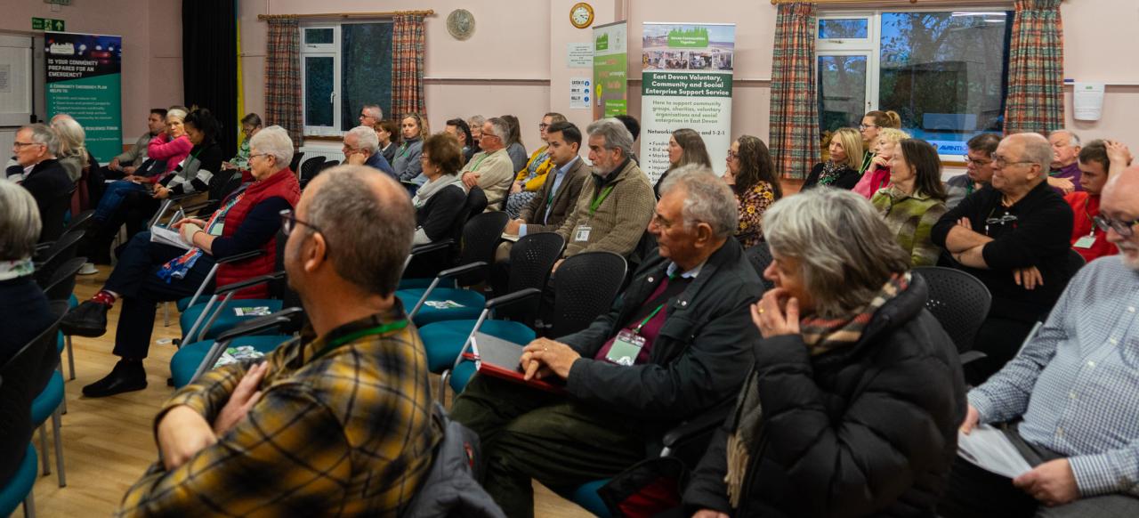 Group of people sitting in a village hall 