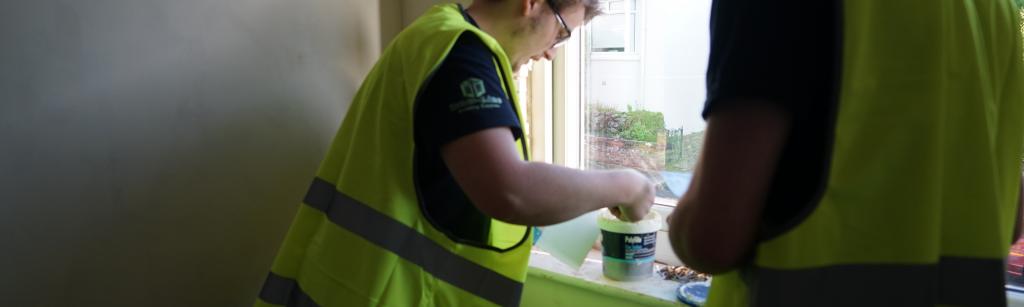 people working on window sill