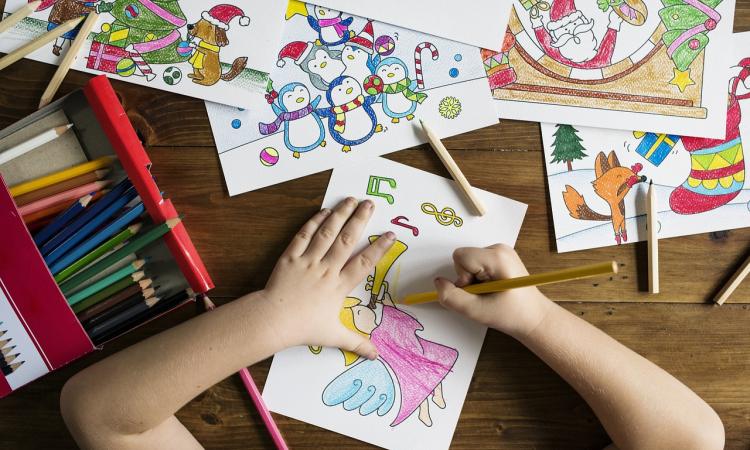 child colouring at a table