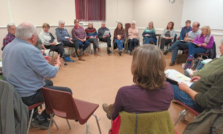 Mid Devon Village Hall Cluster - group of people sitting in a circle on chairs in a village hall