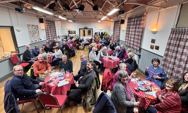 Talaton Village Hall with lots of people at tables for an event