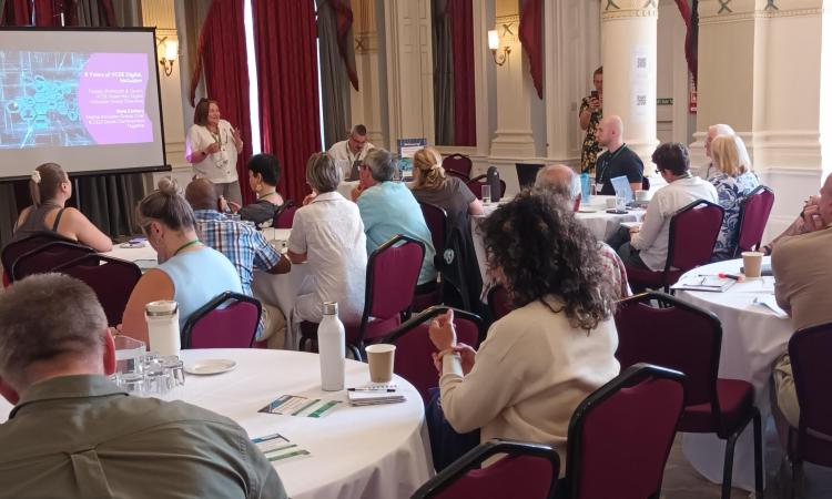 people sat around a table at a conference